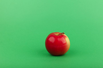 Red apple on green background