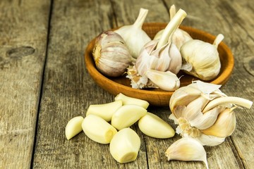 Garlic on kitchen table. Healthy ingredients for food. Traditional flu treatment. Garlic when preparing food. Spices against flu.
