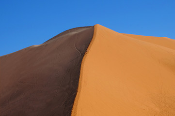 Fototapeta na wymiar minimalism blue and orange sand dunes in the desert
