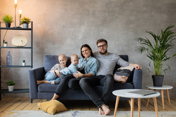 Obraz premium Young Family Playing Together on the Sofa. happy family. home comfort.