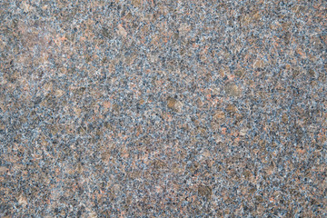 Black granite with pale red spots. Granite slab with pink and beige light crystals of stone. Textured Background. Mica, feldspar, and quartz are visible in the section.