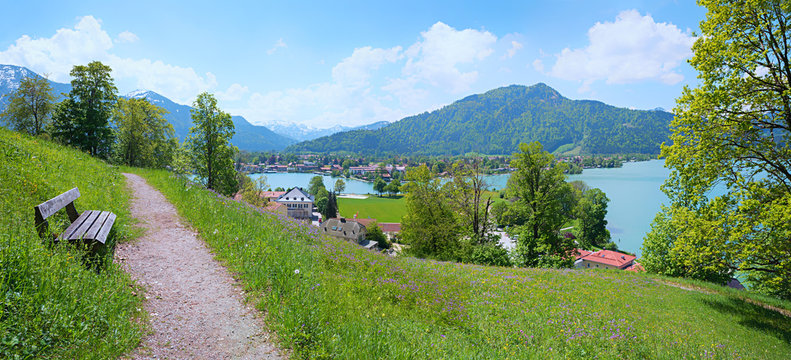 viewpoint Leeberg hill, above lake tegernsee, recreational area with bench and flower meadow, at springtime. landscape bavaria