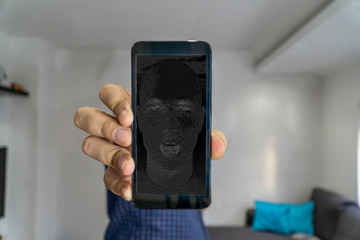 AI haking concept. Man showing digital face on phone screen.
