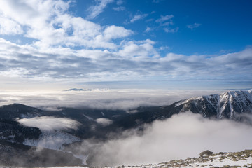 Snow covered mountains with clouds and mist in valley, Low Tatras Dumbier, Slovakia