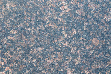 Black granite with pale red spots. Granite slab with pink and beige light crystals of stone....