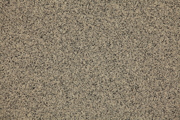 Fototapeta premium Mosaic and granulated textured coating, texture, background. Structural plaster, rough, uneven surface in brown color. Modern exterior cladding of multi-story buildings