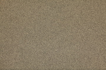 Mosaic and granulated textured coating, texture, background. Structural plaster, rough, uneven surface in brown color. Modern exterior cladding of multi-story buildings