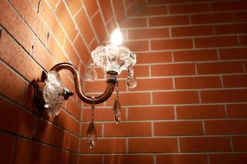 Lamp on brick wall