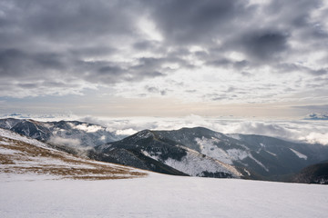 Snow covered mountains with clouds and mist in valley, Low Tatras Dumbier, Slovakia