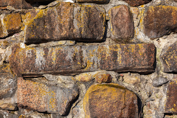ancient wall of granite boulders as background