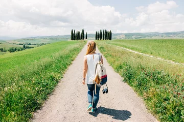 Fotobehang Toscane Young female traveler walking in Tuscany countryside  © marjan4782