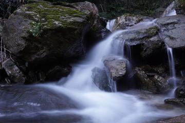 Fototapeta na wymiar Water flows into a mountain river