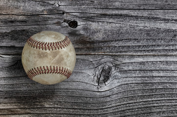 Single used baseball on vintage wooden background. Baseball sports concept with copy space
