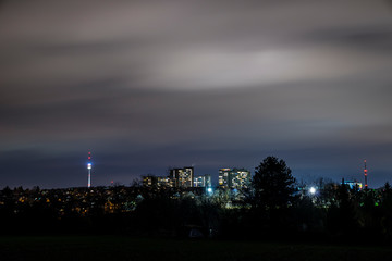 Germany, Magical night sky over skyline of city stuttgart illuminated skyscrapers and tv tower building