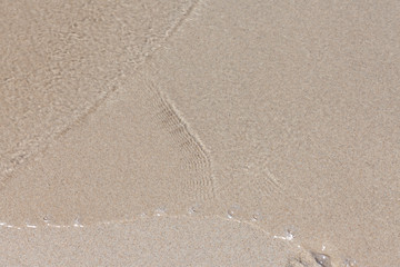 Sea water and sand, top view.