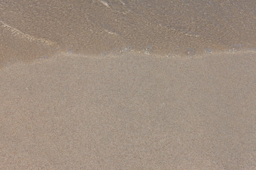 Fototapeta na wymiar Sea water and sand, top view.