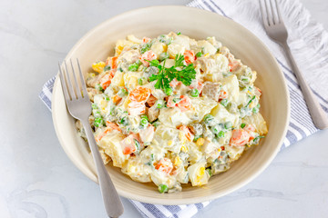 Traditional Russian salad Olivier in a Bowl Top View, White Background, Popular Russian Food Horizontal Stock Photo