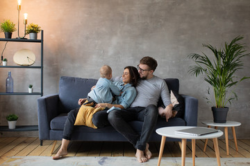 Young Family Playing Together on the Sofa. happy family. home comfort.