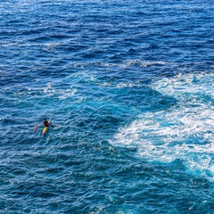 man swimming in the sea