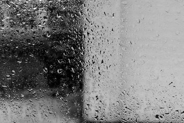 Drops of rain on the misted glass, abstract background