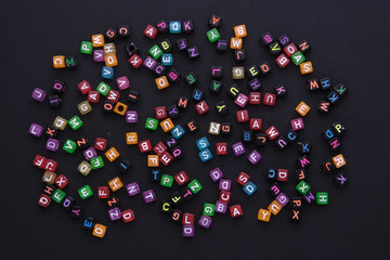 multicolored cubes with letters on a black background