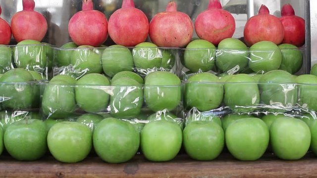 Apples and pomegranates arranged symmetrically