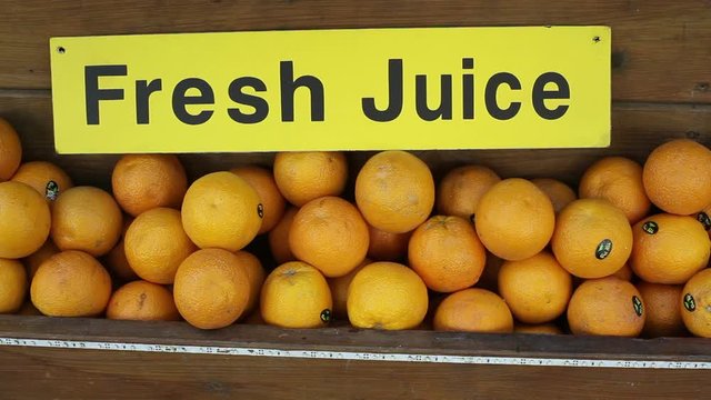 Fresh juice sign, oranges at juice stand