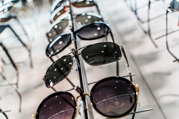 Sunglasses in a store. Row of luxury eyeglass at an opticians store