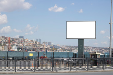 Blank white advertising sign close-up. In the background, the Bosphorus passes in the foreground.