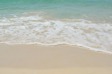 Fototapeta na wymiar Beautiful fluffy sea waves on sandy beach. Blue crystal water. Fine, clean, white, sand like flour. Sunny Tropical seashore of Ko Rok Yai island, South Thailand, Andaman Sea. Summer nature background.