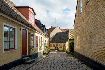 Fototapeta na wymiar University town Lund, southern Sweden. Colorful houses in cobblestone street in the city center.