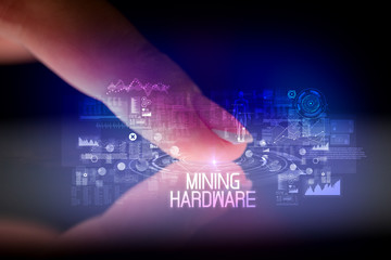 Finger touching tablet with web technology icons and MINING HARDWARE inscription