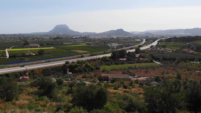 Aerial view of the AP7 highway in the cities of Ondara and Denia, Spain. Montgo mountain is in the background.