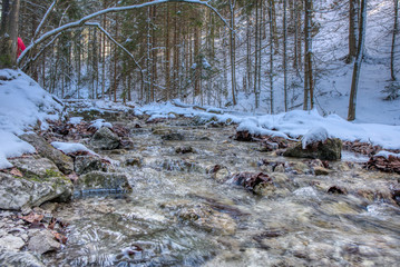 mountain stream in snowy landscape in mountains, slovakia mala fatra