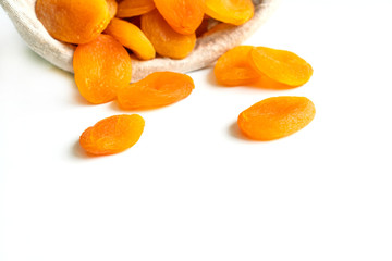 Heap of dried apricots isolated on white background, close up with copy space.