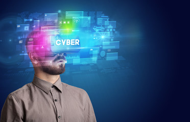 Businessman looking through Virtual Reality glasses with CYBER inscription, innovative security concept