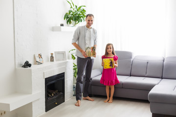 father and daughter hold photo canvas in the interior