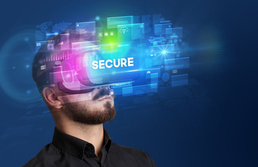 Businessman looking through Virtual Reality glasses with SECURE inscription, innovative security concept