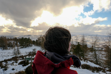 Woman on top of mountain in snow