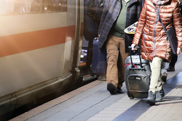 Fernzug am Bahnhof mit ein- und aussteigenden Fahrgästen
