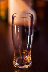 empty beer glass on wooden table close up
