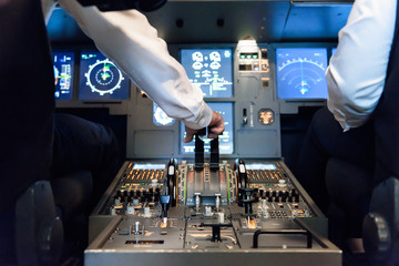 Close up of a pilot who is operating controls from the cockpit