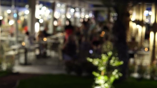 Out of focus image of outdoor restaurant at night.