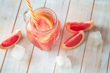 Grapefruit cocktail with juice, cold summer citrus refreshing drink or beverage with ice cubes