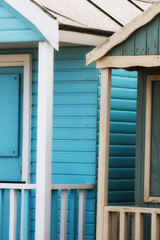 Obraz premium Abstract view of Beach huts. Sutton on Sea beach hut juxtaposition of colours and structure of huts. Various colours in vivid shades and brightness. Summertime holiday resort.