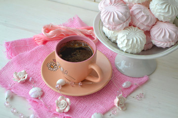 Cup of espresso coffee and homemade zephyr or marshmallow on pink napkin and shabby background