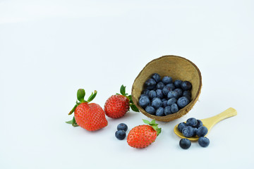 Blueberries and strawberries isolated on white background. Sweet summer fruits.