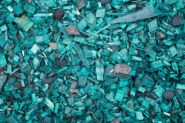 Texture of turquoise brightly painted wood shavings