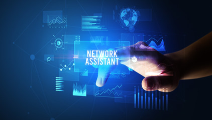 Hand touching NETWORK ASSISTANT inscription, new business technology concept
