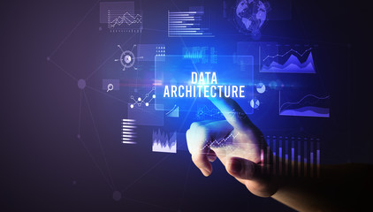 Hand touching DATA ARCHITECTURE inscription, new business technology concept